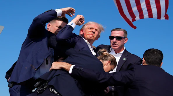 Donald Trump narrowly escapes an assassination attempt.